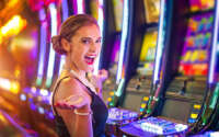 Young woman playing slot machines at the Casino